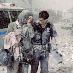Police officer Mike Brennan helps a distraught woman known only as Beverly, as ash and debris cover the area following the collapse of 1 World Trade Center. (Photo by Corey Sipkin/NY Daily News Archive via Getty Images)
