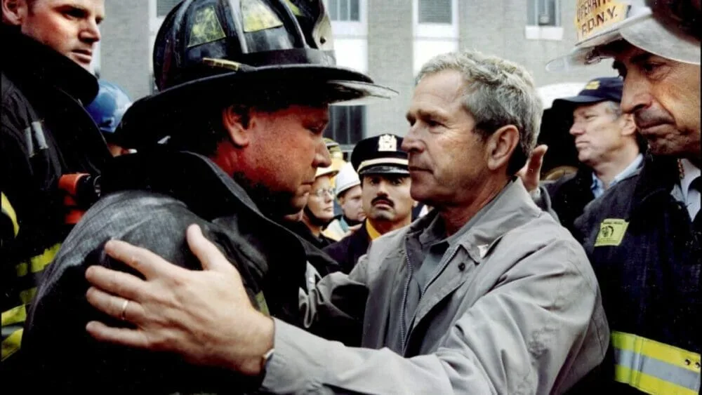 President George W. Bush embraces a firefighter during a visit to New York on Sept. 14, 2001