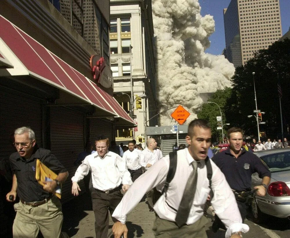Stephen Cooper, who died of COVID-19, can be seen wearing a black shirt and glasses on the far left. He was delivering newspapers when the Twin Towers were hit on September 11, 2001.
