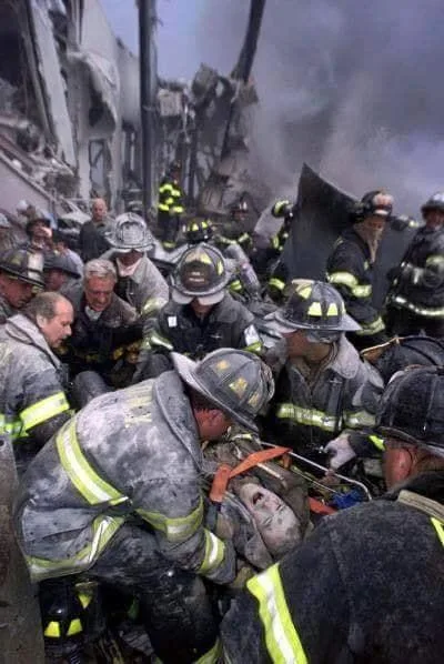 Screaming in pain, one firefighter is pulled from rubble where 343 colleagues died.