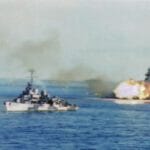 A battleship firing the big guns at the beach-167 A battleship firing the big guns at the beach