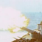 A battleship firing the big guns at the beach-836 A battleship firing the big guns at the beach