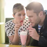Couple enjoying a milkshake