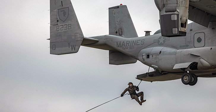 Marine repelling out of an OV-22 Osprey