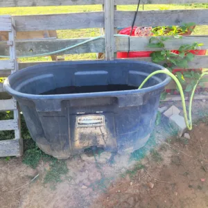 Refilling the 100-Gallon Water Trough for the horses